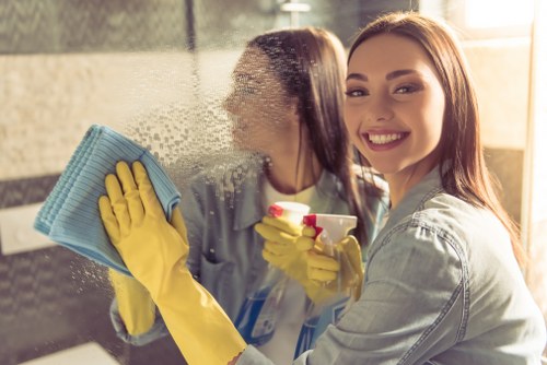 Cleaner wearing PPE while operating carpet cleaning equipment